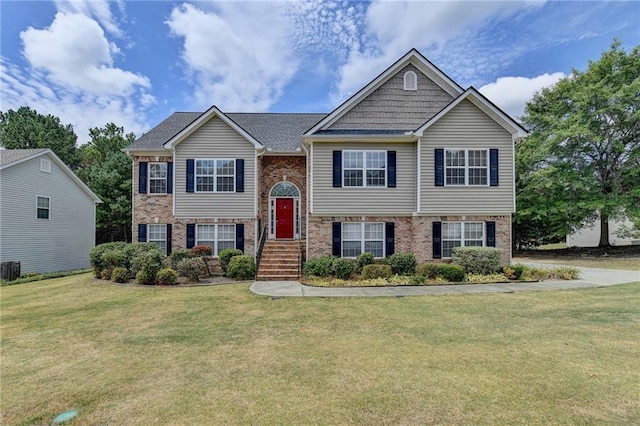 split foyer home featuring a front lawn