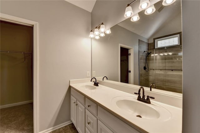 bathroom featuring vanity, an enclosed shower, and lofted ceiling