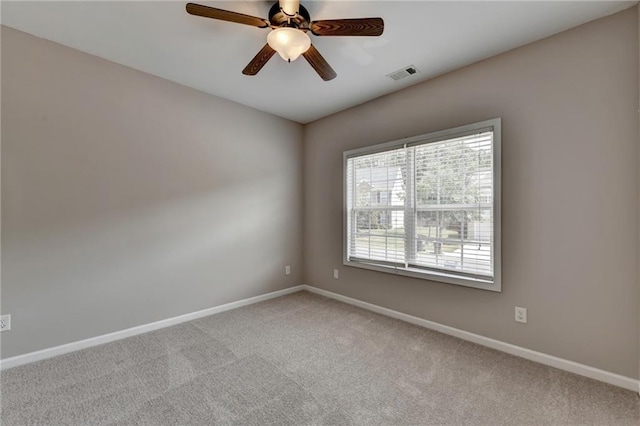 carpeted spare room with ceiling fan