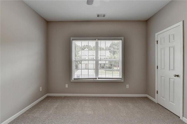 spare room featuring light colored carpet