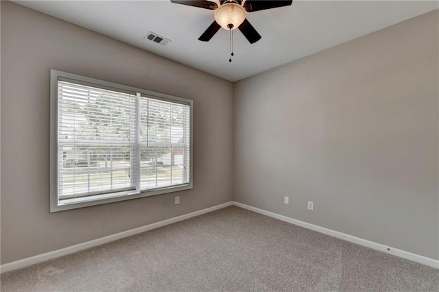 carpeted spare room with ceiling fan