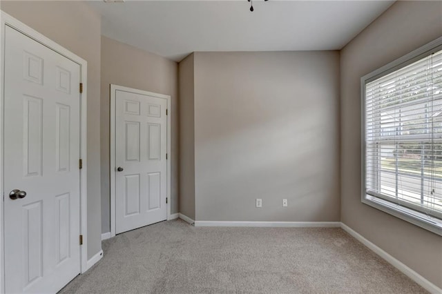 unfurnished room with light carpet