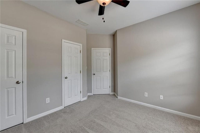 unfurnished bedroom featuring ceiling fan and light carpet