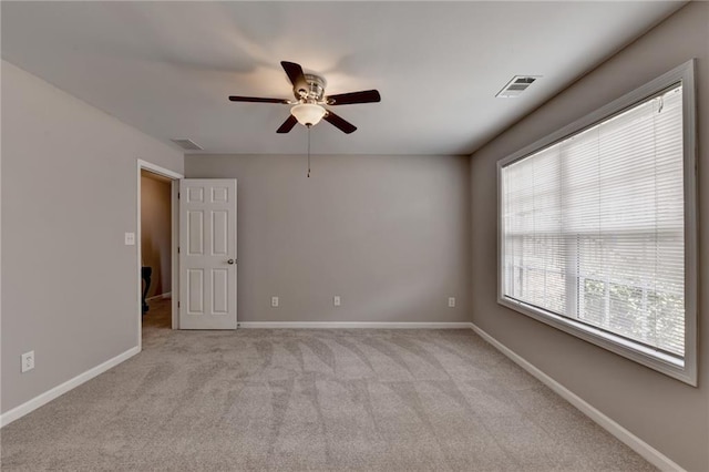 unfurnished room with ceiling fan and light colored carpet