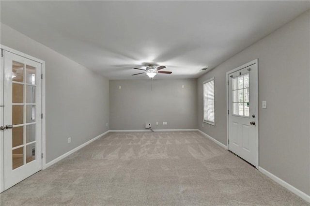 interior space with light colored carpet and ceiling fan