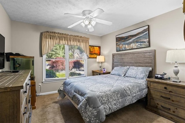 carpeted bedroom featuring baseboards, a ceiling fan, and a textured ceiling