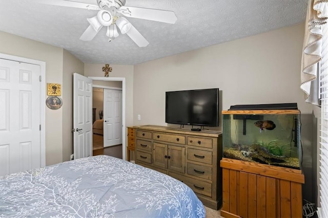 bedroom with a textured ceiling and a ceiling fan