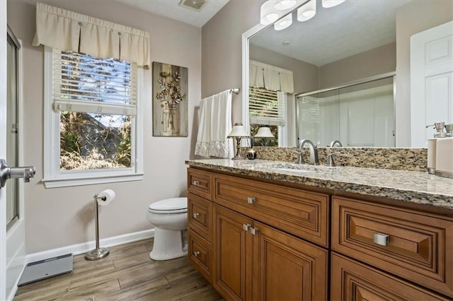full bathroom with baseboards, wood finished floors, an enclosed shower, toilet, and vanity