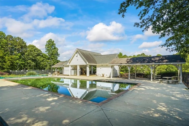 view of swimming pool with fence and a patio