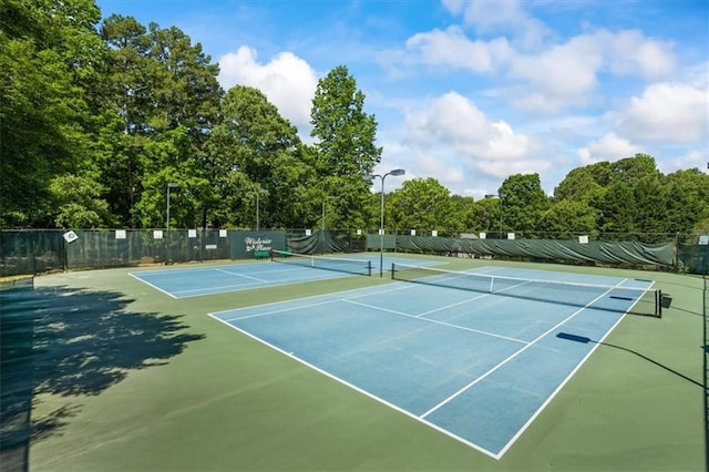 view of tennis court featuring fence and community basketball court