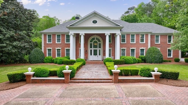 greek revival house featuring brick siding