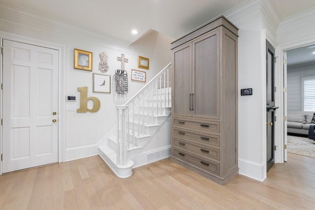 foyer entrance with crown molding, stairs, baseboards, light wood-style floors, and recessed lighting
