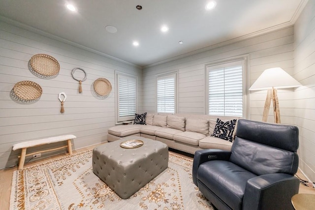living room featuring crown molding, recessed lighting, and wood walls