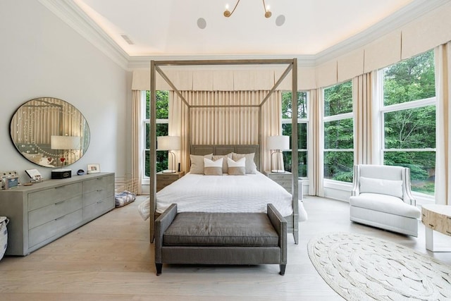 bedroom with ornamental molding, wood finished floors, and visible vents
