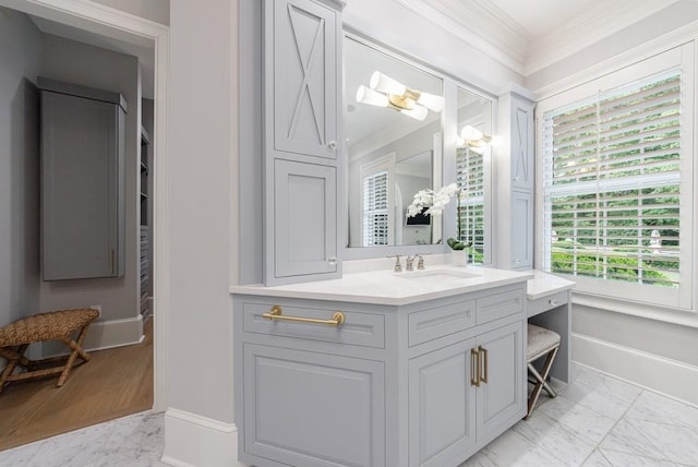 bathroom featuring baseboards, ornamental molding, marble finish floor, and vanity
