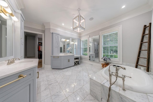 full bath with an inviting chandelier, a garden tub, ornamental molding, two vanities, and a sink