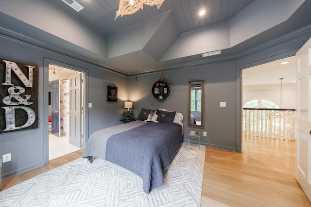 bedroom with a notable chandelier, visible vents, wood ceiling, and light wood-type flooring