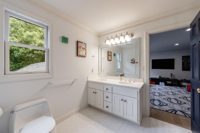bathroom featuring a sink, ornamental molding, plenty of natural light, and toilet