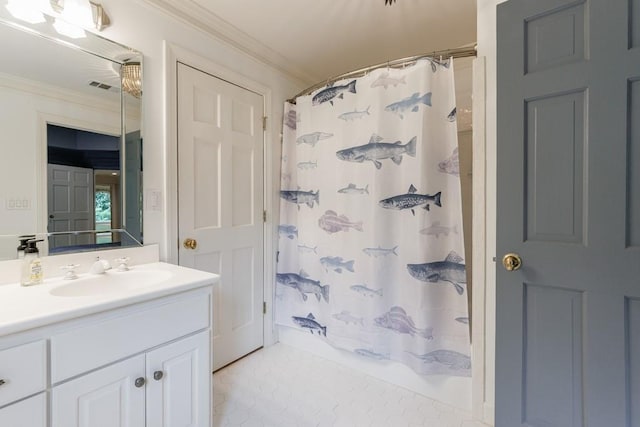 bathroom featuring crown molding, visible vents, and vanity