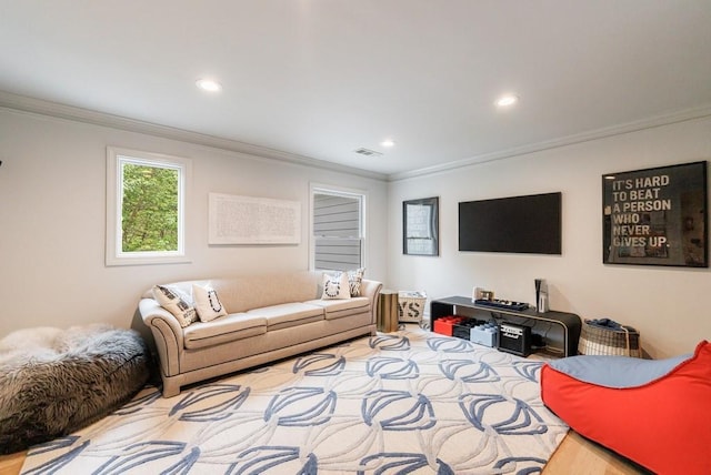 living area featuring crown molding, recessed lighting, and visible vents