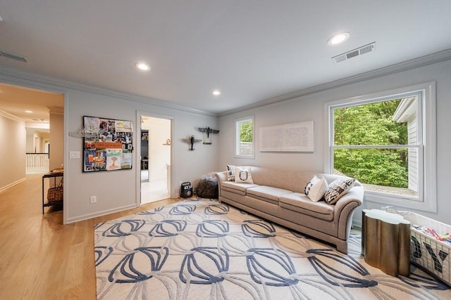 living room featuring recessed lighting, visible vents, ornamental molding, and light wood-style floors