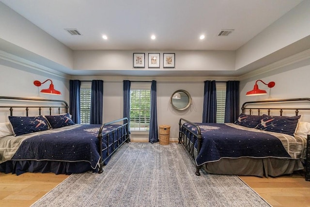 bedroom with recessed lighting, visible vents, and wood finished floors