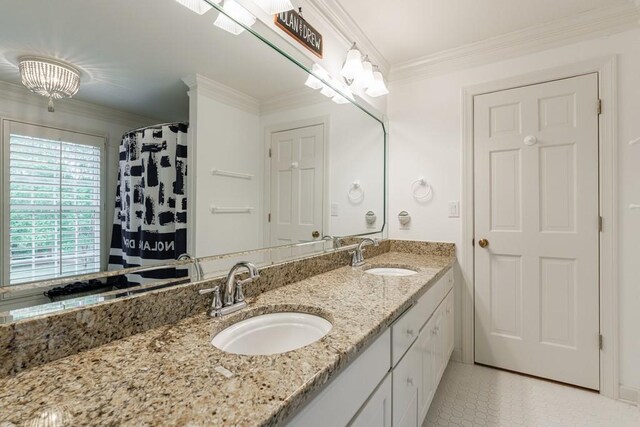 bathroom featuring double vanity, ornamental molding, a sink, and tile patterned flooring