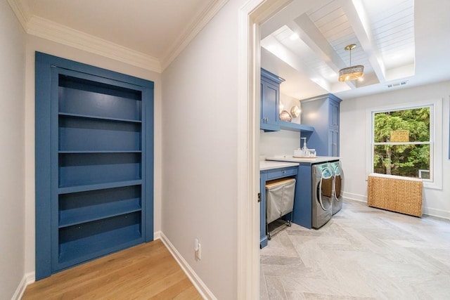 laundry room with cabinet space, crown molding, washing machine and clothes dryer, baseboards, and visible vents