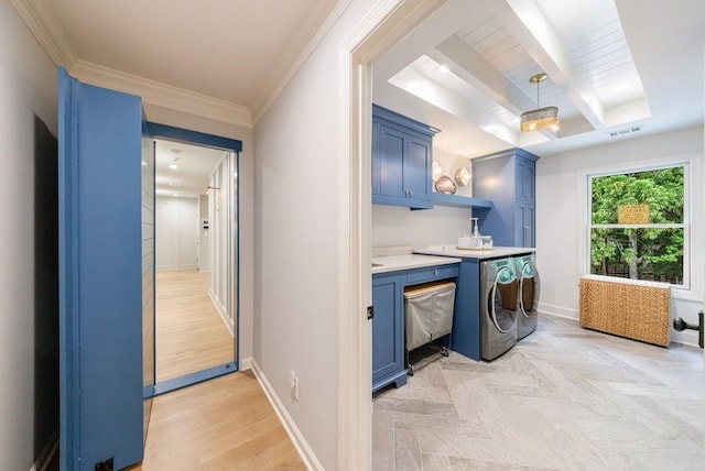 washroom featuring parquet flooring, visible vents, washing machine and dryer, cabinet space, and baseboards