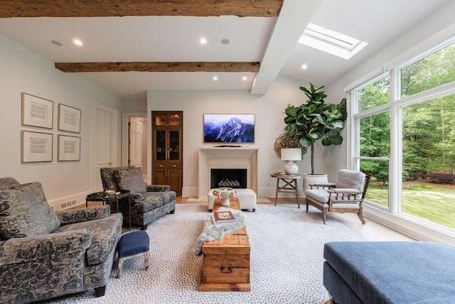 living room featuring visible vents, recessed lighting, a fireplace, and a skylight