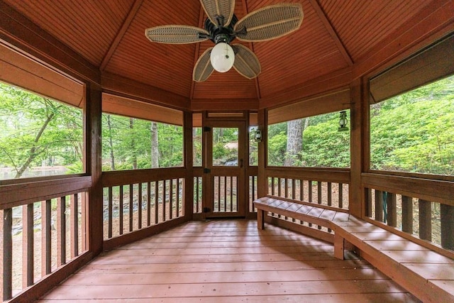 unfurnished sunroom featuring ceiling fan