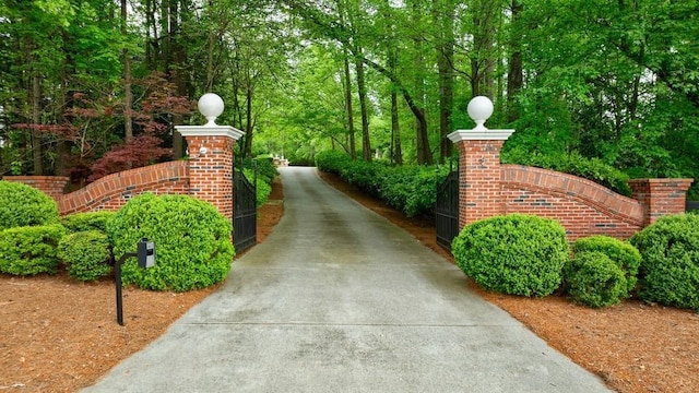exterior space with fence, a gate, and driveway