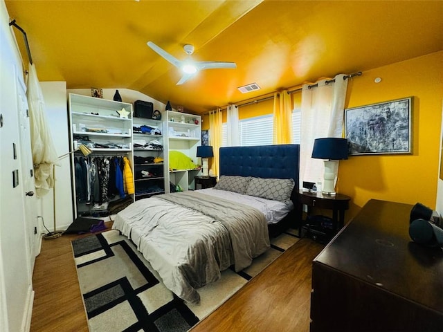 bedroom with wood-type flooring, ceiling fan, and lofted ceiling