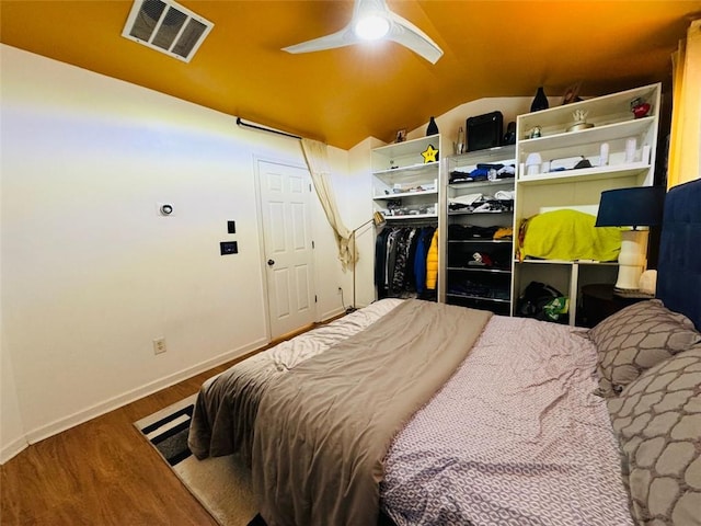 bedroom with wood-type flooring, lofted ceiling, and ceiling fan