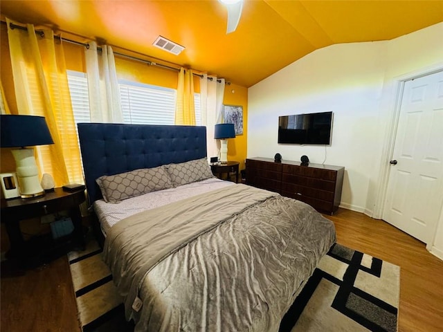 bedroom featuring ceiling fan, wood-type flooring, and vaulted ceiling