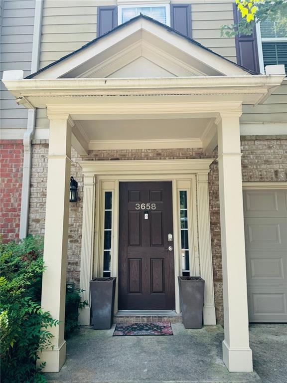 view of exterior entry featuring a garage