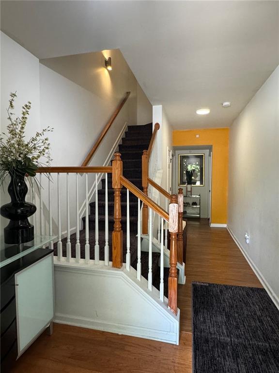 staircase with dark wood-type flooring