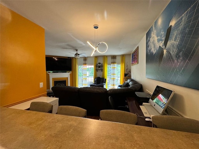 living room with ceiling fan with notable chandelier