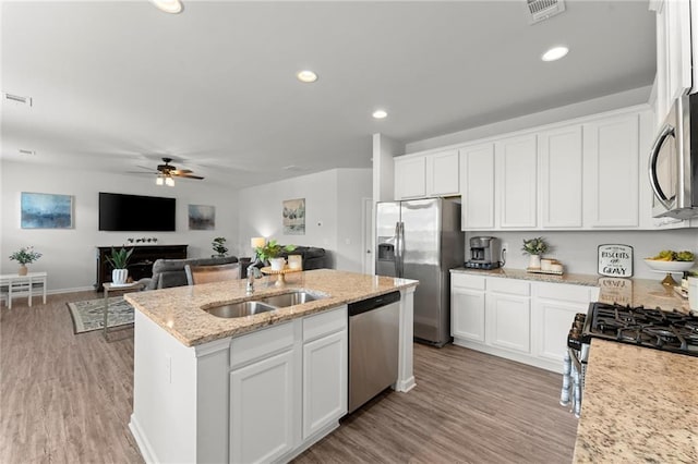 34 Hemlock Gln, Dallas, GA 30132 - kitchen featuring stainless steel appliances, a sink, a ceiling fan, an island with sink, and white cabinets