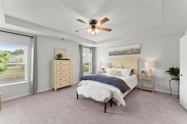 34 Hemlock Gln, Dallas, GA 30132 - bedroom featuring a tray ceiling, light carpet, baseboards, and a ceiling fan