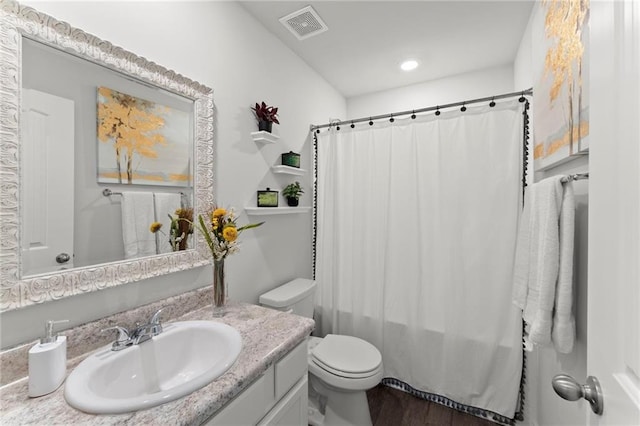 34 Hemlock Gln, Dallas, GA 30132 - bathroom with toilet, vanity, wood finished floors, shower / bath combination with curtain, and recessed lighting