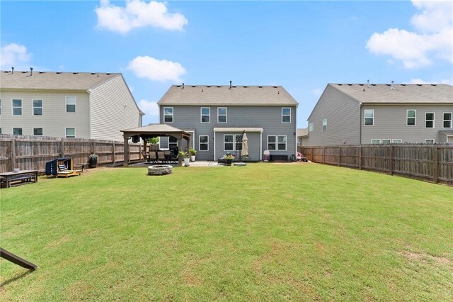 34 Hemlock Gln, Dallas, GA 30132 - back of house with a gazebo, a patio area, and an outdoor living space with a fire pit