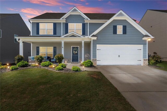 34 Hemlock Gln, Dallas, GA 30132 - view of front of property with covered porch, concrete driveway, a front yard, and an attached garage