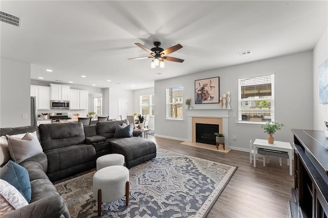 34 Hemlock Gln, Dallas, GA 30132 - living room with a fireplace with raised hearth, plenty of natural light, ceiling fan, wood finished floors, and recessed lighting