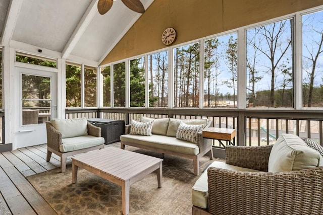 sunroom / solarium with vaulted ceiling, a wealth of natural light, and ceiling fan