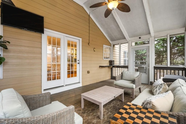 sunroom featuring lofted ceiling with beams and a ceiling fan