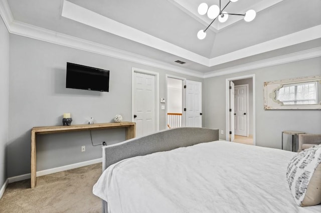 bedroom featuring a tray ceiling, baseboards, carpet flooring, and crown molding