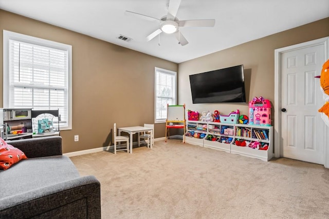 recreation room with visible vents, a ceiling fan, baseboards, and carpet floors