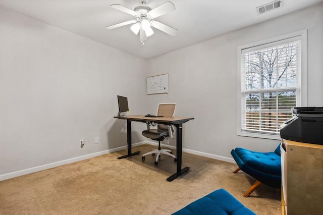 office area featuring carpet flooring, baseboards, visible vents, and ceiling fan