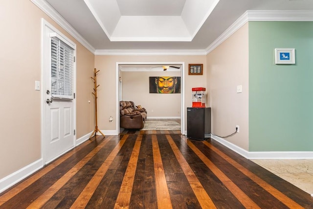 entryway with baseboards, crown molding, and hardwood / wood-style flooring